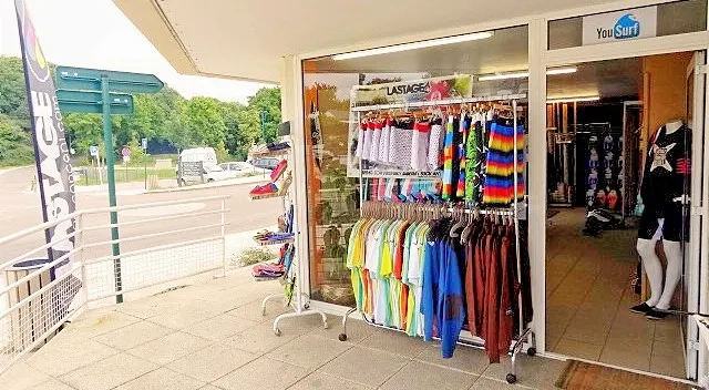 Entrée de la boutique YouSurf avec planches et combinaisons