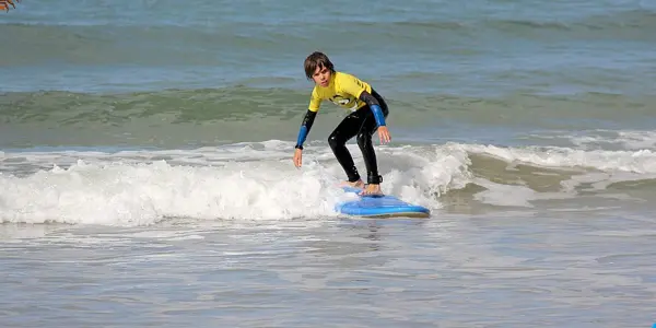 Jeune surfeur debout sur sa planche